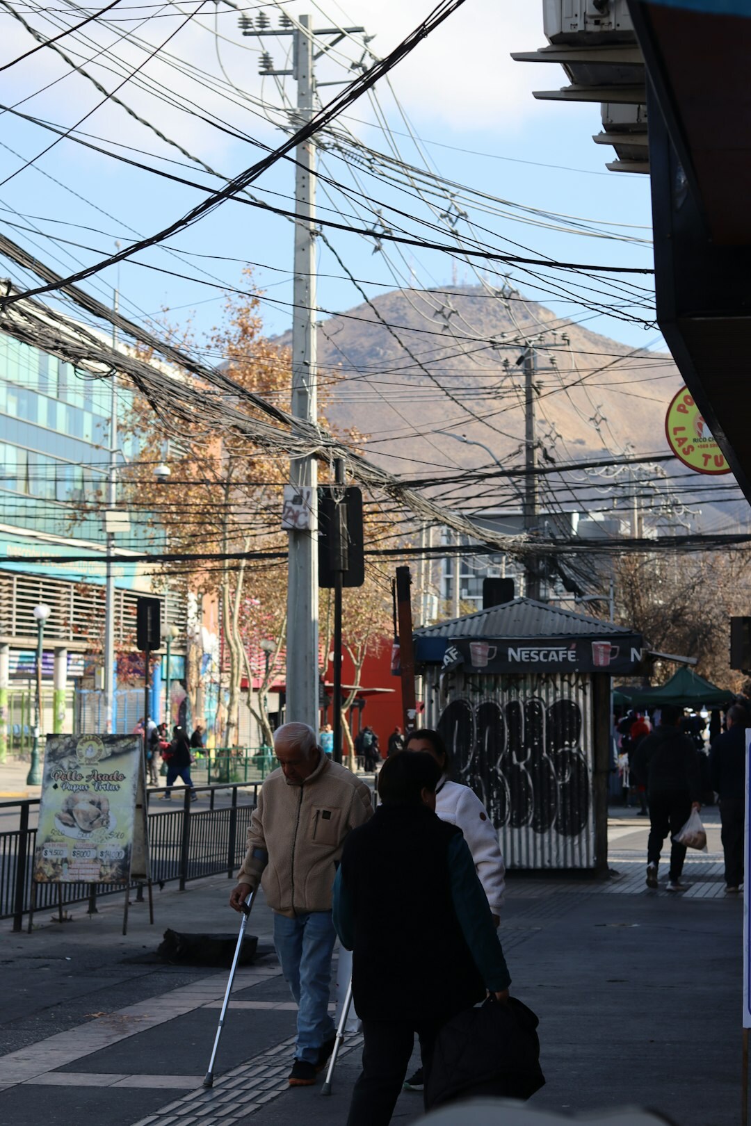 Wide street scene with pedestrians and historic architecture in Chile