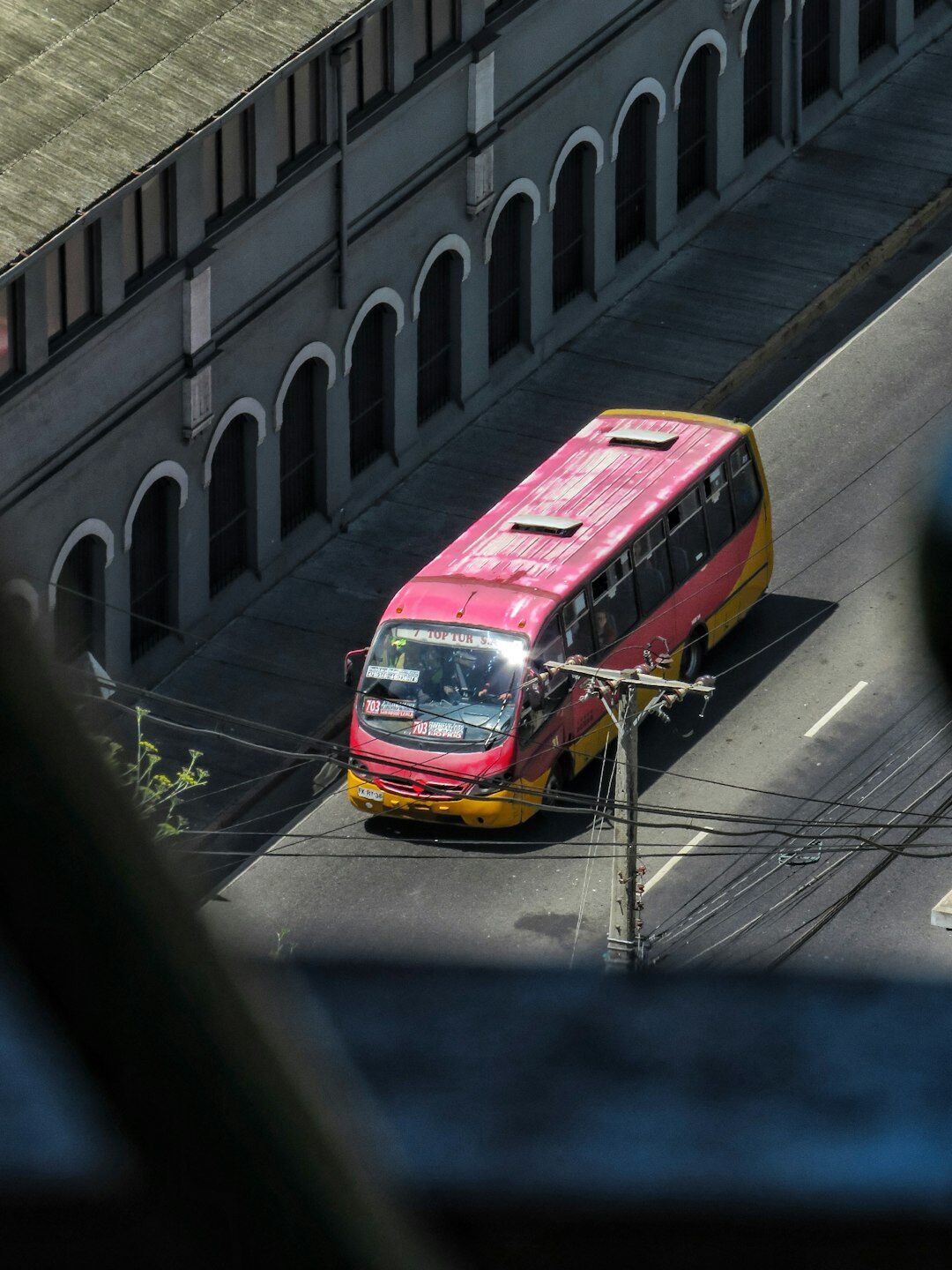 Colorful public bus driving through a city street in Chile